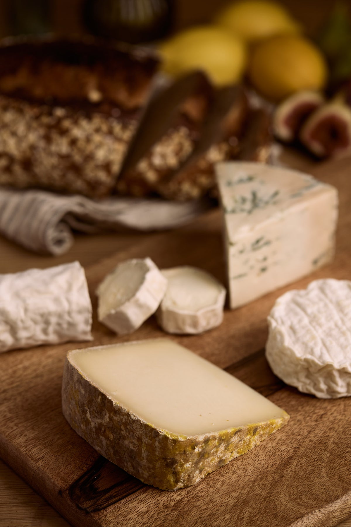 Selection of artisan cheeses with blue and soft cheeses, bread and figs